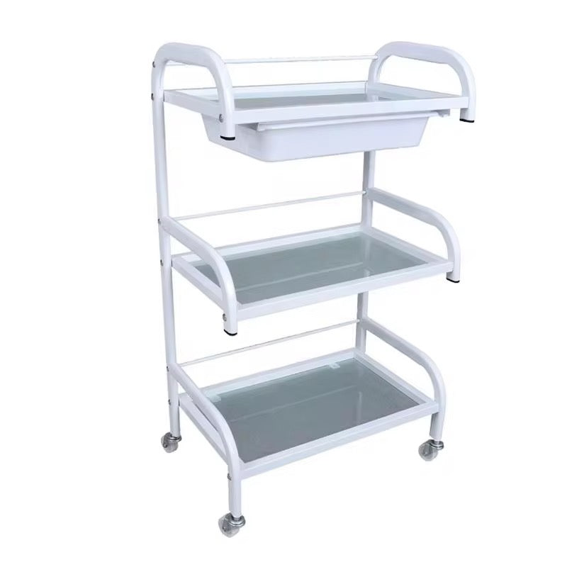 White metal utility cart with three shelves on a white background