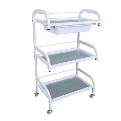 White metal utility cart with three shelves on a white background