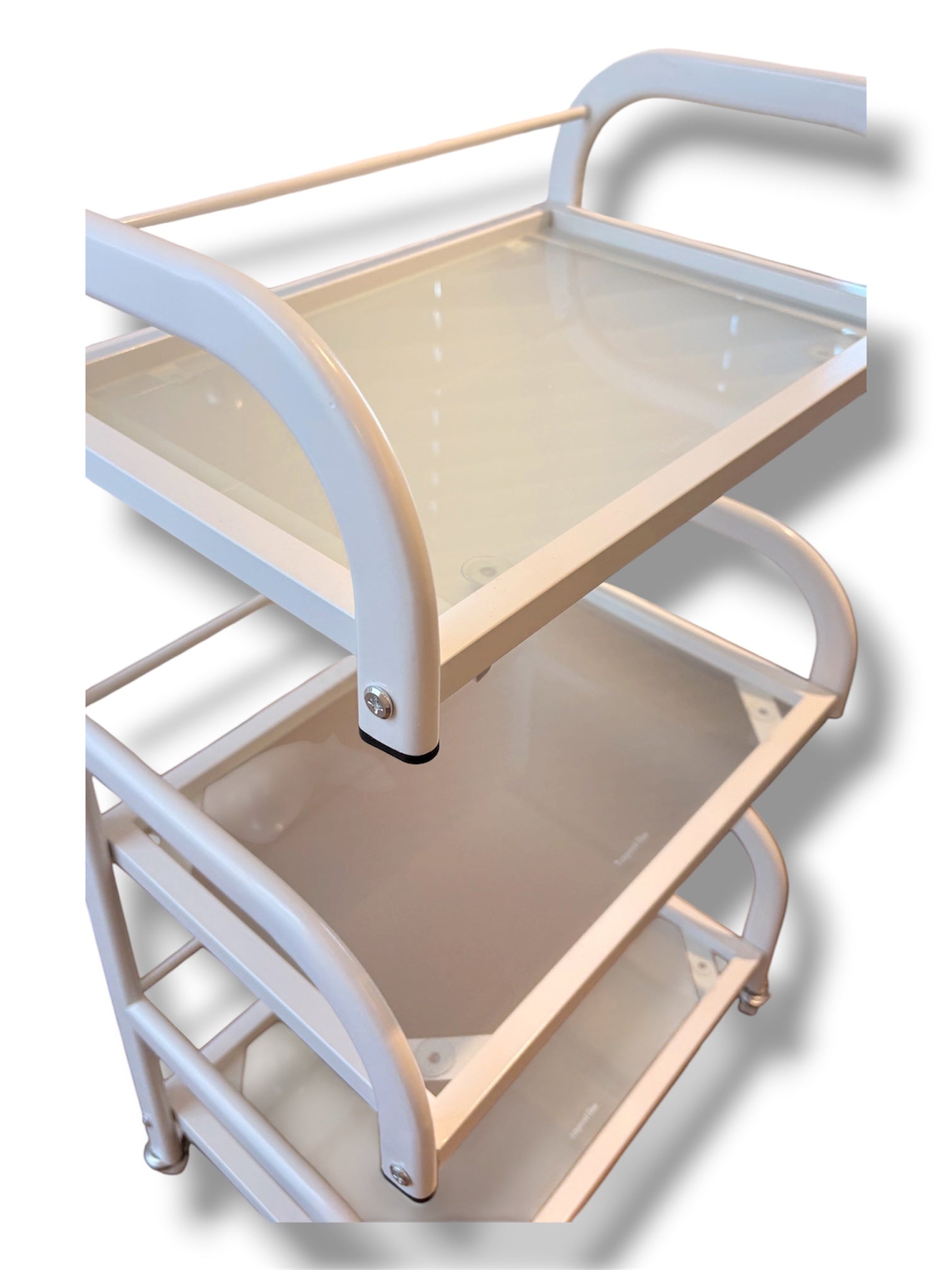 Two-tiered serving cart with beige top and white frame on a white background
