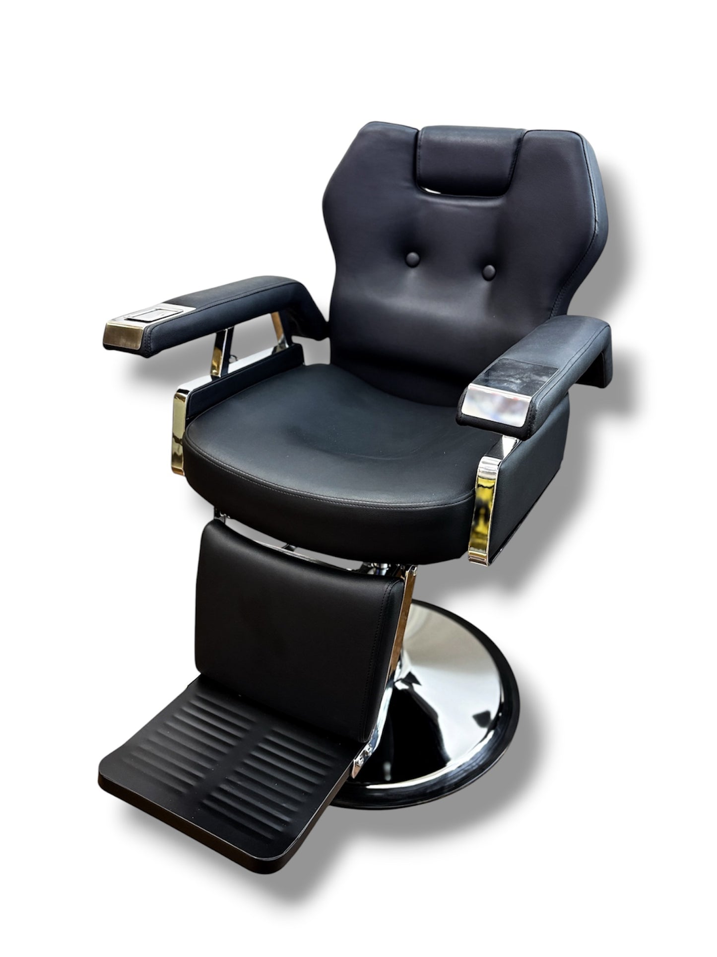 Black barber chair with chrome accents on a white background